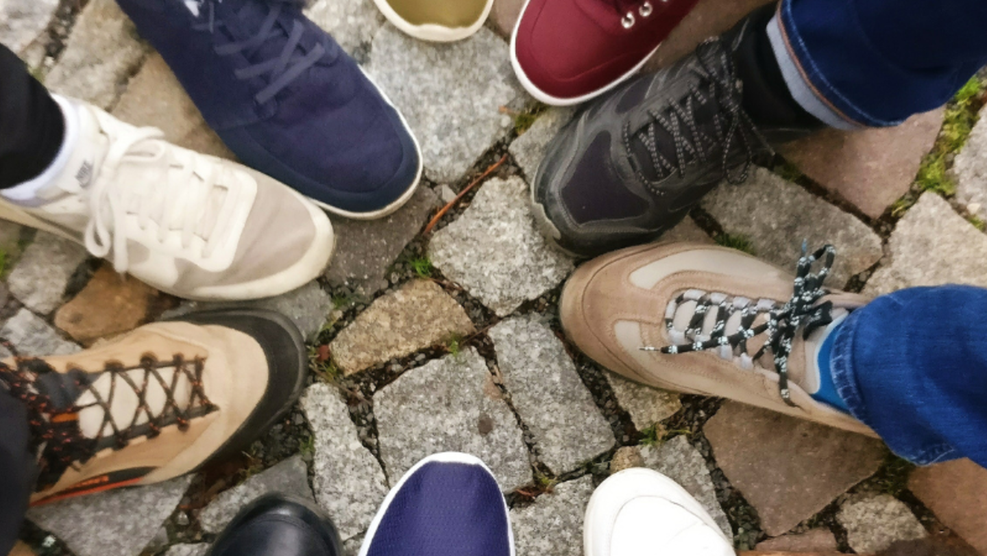 Group of people with their shoes in a circle